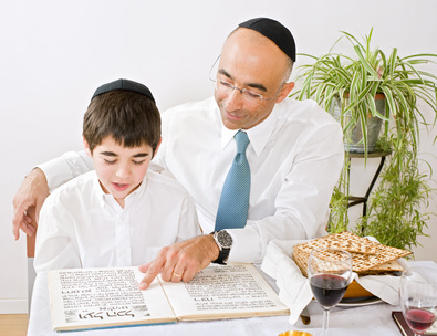 father and son celebrating passover reading the Hagada